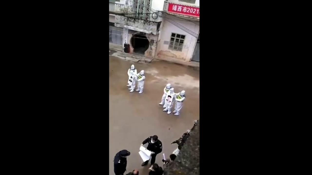 Video shows a group of people Chinese lockdown rule-breakers publicly shamed and paraded through the streets carrying placards with their names and photos.