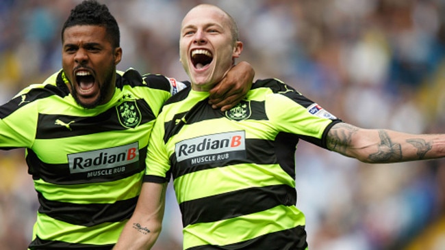 Aaron Mooy celebrates with Elias Kachunga. (Photo by Robbie Jay Barratt — AMA/Getty Images)