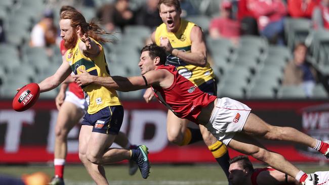 North Adelaide’s Aidan Tropiano lunges to stop Angus Poole in the preliminary final. Picture SARAH REED