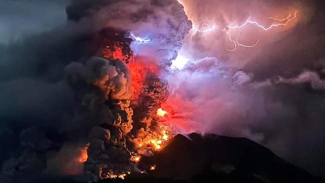 Lightning strikes while lava spews from Mount Ruang. Picture: AFP