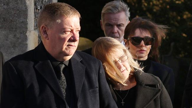 Karen Payne and Geoff Payne, parents of Liam, and Cheryl Tweedy watch the coffin leave following the funeral of singer Liam Payne.