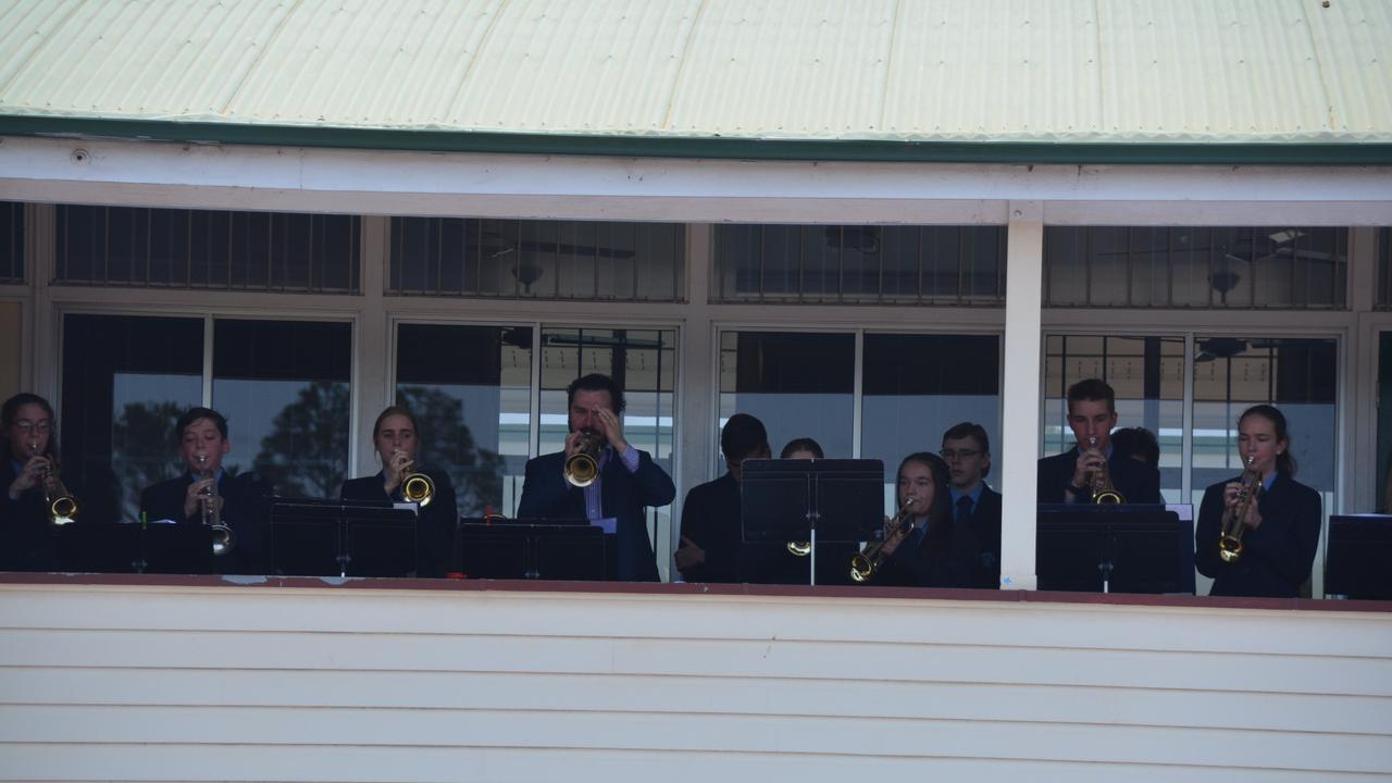 Music teacher Matt Phillips leads Kingaroy State High School trumpeters through their Last Post debut at the 2019 Kingaroy Remembrance Day service. (Photo: Jessica McGrath)