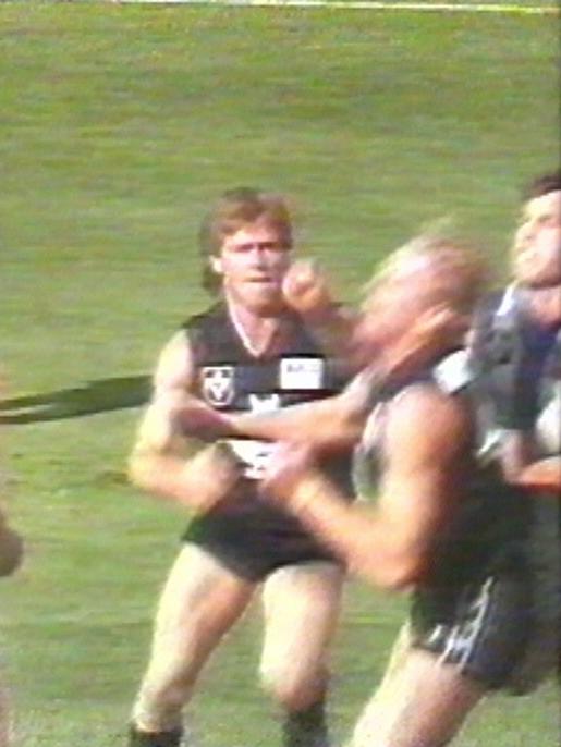 October and Carlton and the Kangas meet at The Oval. A young Alastair Clarkson strikes Ian Aitken in a fiery clash later known as the ‘Battle of Britain’.