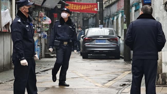 Police patrol a neighborhood in Wuhan, China. Picture: Getty Images