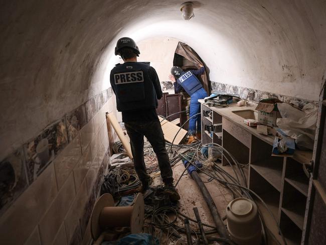 Journalists inside a tunnel that the army claimed is a 