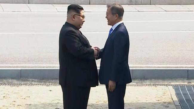 Kim Jong Un and Moon Jae-in shake hands in Panmunjom. Picture: Korea Broadcasting System via AP.