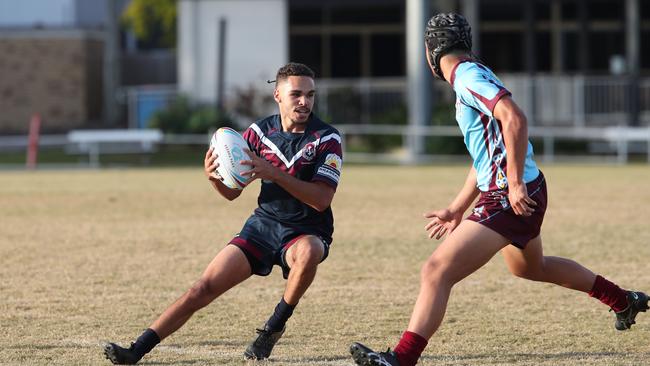 Ipswich’s Jamal Laurie avoids the tackle of Keebras Zin Zan Kahui. Picture Glenn Hampson