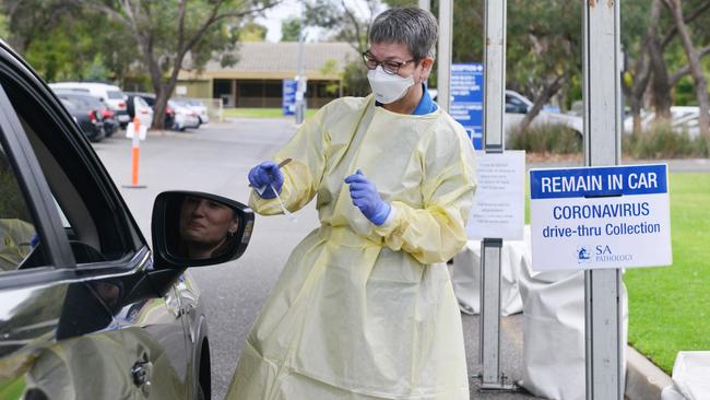 An SA Pathology nurse tests a patient at the new drive-through clinic at Hampstead Rehabilition Clinic, March 24, 2020. Picture: AAP / Brenton Edwards