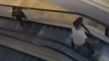 A bystander armed with a bollard tries to stop the armed man on an escalator at Westfield Bondi Junction on Saturday, April 13. Picture: 9 News