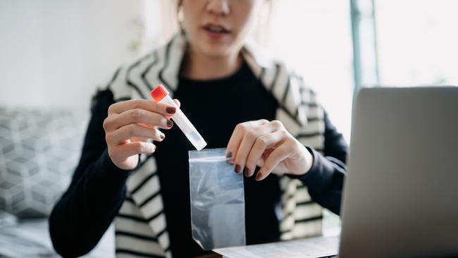 Cropped shot of young Asian woman consulting to her family doctor online in a virtual appointment, holding a medical test tube, conducting Covid-19 diagnostic test at home credit: getty images escape 1 august 2021 doc holiday