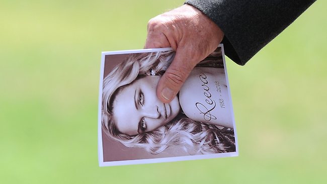 A relative of late South African model Reeva Steenkamp holds the funeral program upon arriving at the crematorium building in Port Elizabeth on February 19, 2013. The 29-year-old law graduate and cover girl was gunned down four times on February 14, 2013 at the upmarket Pretoria home of the Olympic and Paralympic star Oscar Pistorius. South African prosecutors on February 19 told a bail hearing that Oscar Pistorius was guilty of "premeditated murder" in the Valentine's Day killing of his model girlfriend at his upscale home.   AFP PHOTO / ALEXANDER JOE