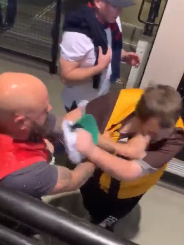 A fight between a Melbourne supporter and a Hawthorn supporter at the MCG. Picture: Channel 9