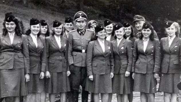 Uniformed women pose for a picture with a male Nazi at Solahütte with Höcker. Picture: US Holocaust Memorial Museum