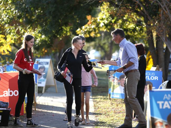 MACARTHUR CHRONICLE/AAP. Hume MP Angus Taylor hands out how to vote pamphlets at Camden Public School polling booth, Saturday, 18th May 2019. (AAP IMAGE / Robert Pozo).