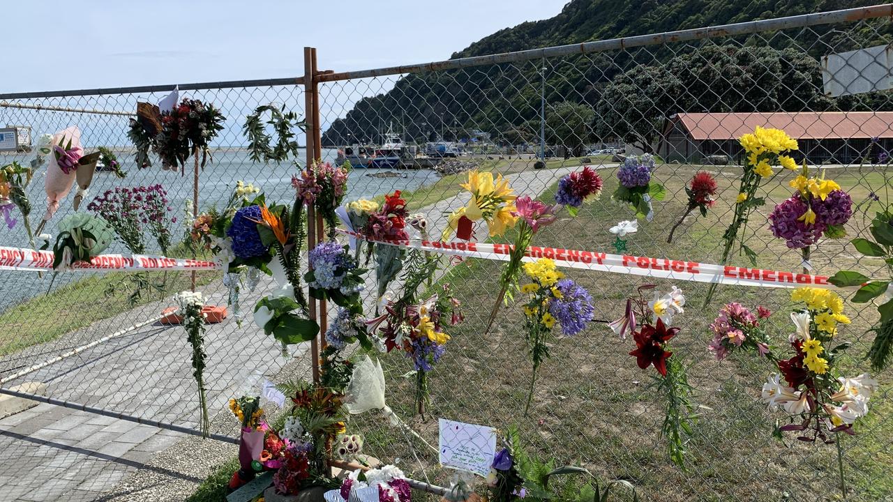 Tributes on a fence near the water in Whakatane, New Zealand. Picture: AAP Image/Ben McKay.