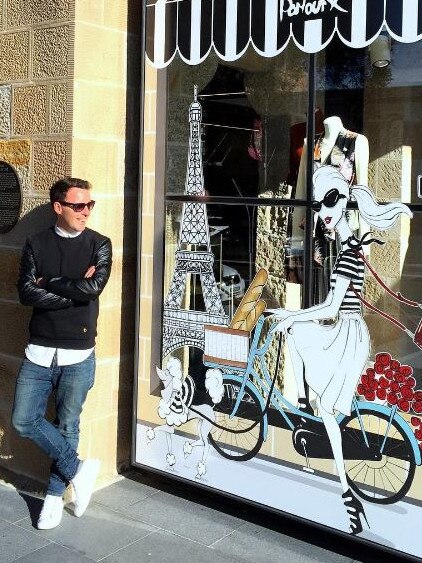 Favaloro in front of one of his works in a shop window.