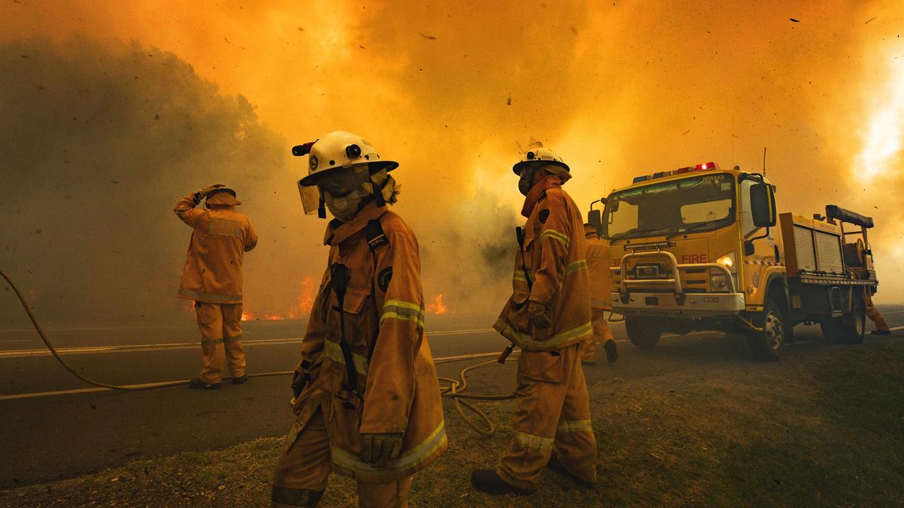 Firefighters on the scene at an out of control bushfire at Peregian Beach, where hundreds of residents were evacuated yet again. Photo Lachie Millard