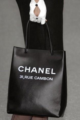 Karl Lagerfeld brings out a Chanel shopping bag - Vogue Australia