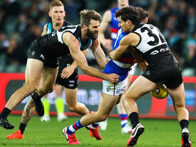 ADELAIDE, AUSTRALIA - AUGUST 03: Justin Westhoff of the Power and Sam Mayes of the Power lay a tackle during the round 10 AFL match between the Port Adelaide Power and the Western Bulldogs at Adelaide Oval on August 03, 2020 in Adelaide, Australia. (Photo by Daniel Kalisz/Getty Images)