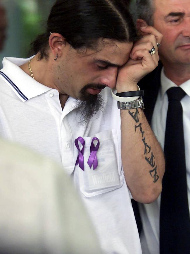 The killer cries for his wife at her funeral. File pictures