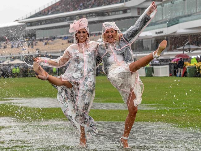 Sisters Taylor Harrang, 22, and Emma Harrang, 23 didn’t let the weather dampen their spirits. Picture: Jason Edwards