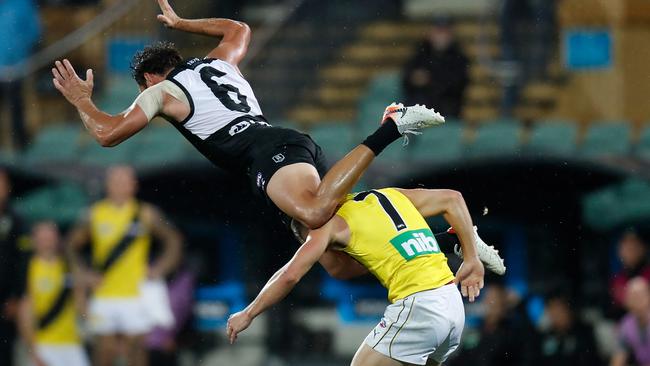 Steven Motlop launches over Liam Baker. Picture: Michael Willson/AFL Photos via Getty Images