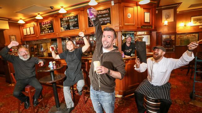 Mark Harrison, Joseph Tan, John Davie, Eric Fleming, and Joseph Weir are glad to see the Charles Dickens pub reopen. Picture: Alex Coppel.