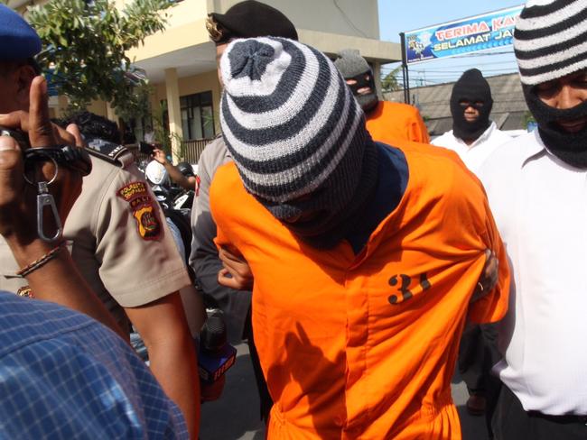 Australian Guiseppe Serafino escorted by police during press conference of his case at Denpasar police station in Bali. Picture: Supplied