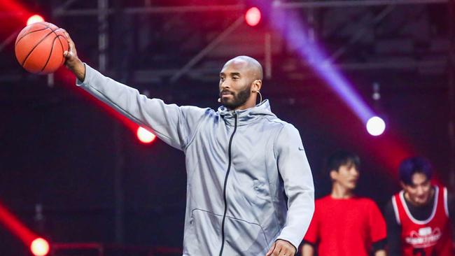 Retired basketball star Kobe Bryant gets the crowd pumped up.