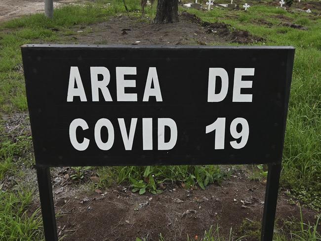 A signal that reads "COVID-19 area" is seen at the La Verbena cemetery in Guatemala City, on June 17, 2021. - As of June 16, 2021, Guatemala reported more than 276,927 infections and 8,549 deaths. (Photo by Johan ORDONEZ / AFP)