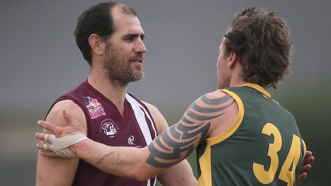 OSB Lonsdale's Trevor Rigney is congratulated by Marion's Dean Saunders, for kicking 100 goals in 2018. Picture: Dean Martin