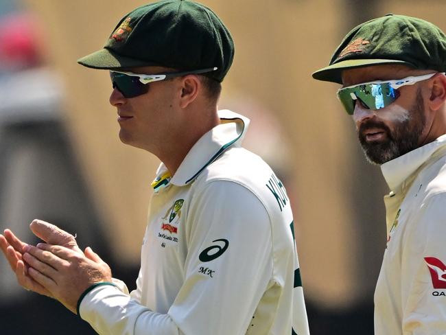 Australia's Nathan Lyon (R) and Matthew Kuhnemann walk back to the pavilion at the end of the Sri Lanka innings during the fourth day of the second Test cricket match between Sri Lanka and Australia at the Galle International Cricket Stadium in Galle on February 9, 2025. (Photo by Ishara S. KODIKARA / AFP)