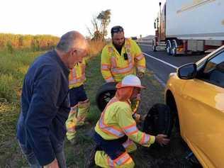 Road workers come to the rescue of a couple stranded on the Pacific Highway. Picture: Contributed