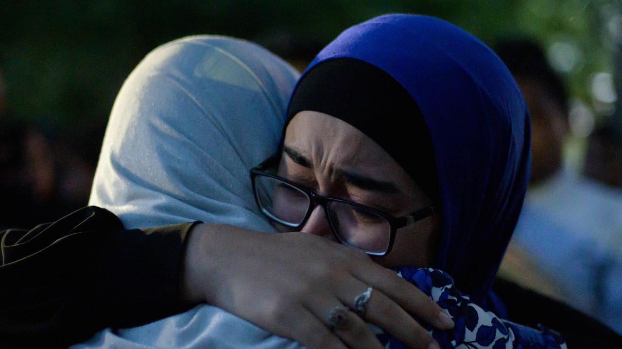 Two women cry and hug after watching a performance of the haka in front of the Al Noor mosque as a tribute to victims in Christchurch. Picture: AFP