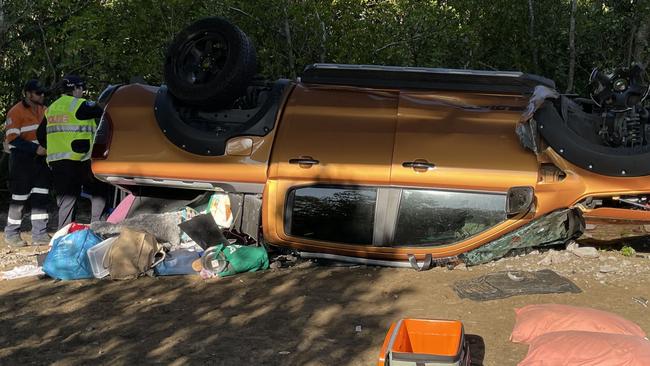 Police inspect where a vehicle and trailer has come off a bridge and rolled down a river bank south of Mackay. Photo: Janessa Ekert.