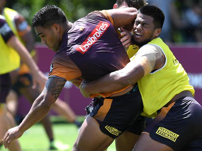 Brisbane Broncos rookie Payne Haas (right) tackles teammate Joe Ofahengaue . Picture: AAP Image/Dan Peled