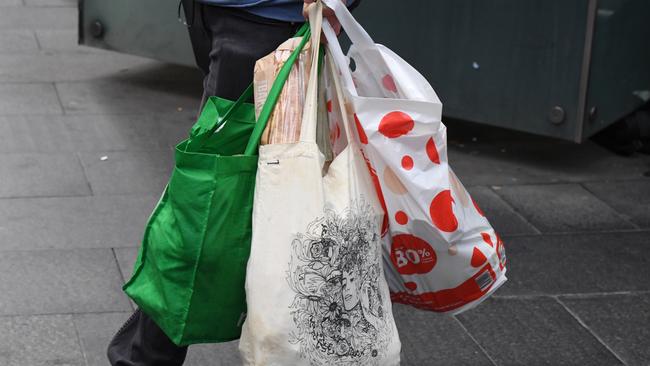 A shopper is seen carrying bags at a Coles Sydney CBD store, Sydney, Monday, July 2, 2018. Woolworths says it will hand out free reusable bags for the next 10 days as its customers get used to its ban on single-use plastic bags. Woolies stores in NSW, Queensland, Victoria and Western Australia stopped providing free single-use plastic bags on June 20. (AAP Image/Peter RAE) NO ARCHIVING