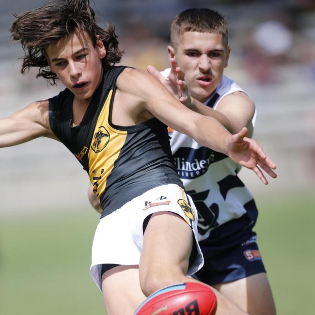 Glenelg’s Lucas Camporeale just gets his boot to the ball under immense pressure. Picture: Supplied, Cory Sutton, SANFL