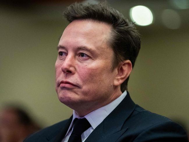 Elon Musk listens as US President-elect Donald Trump speaks during a meeting with House Republicans at the Hyatt Regency hotel in Washington, DC on November 13, 2024. (Photo by Allison ROBBERT / POOL / AFP)