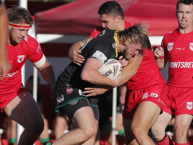 Cameron Newell of Helensvale Hornets is tackled. Photo: Regi Varghese