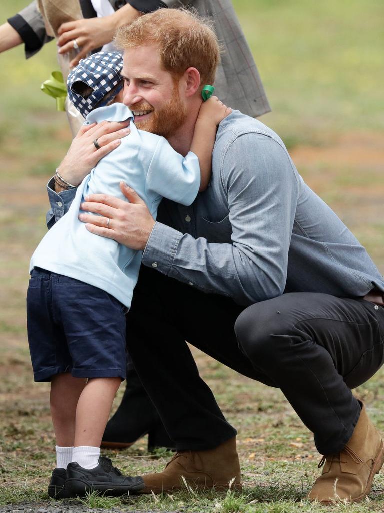 Luke hugs Prince Harry.