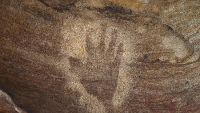 Some of the aboriginal art which is untouched in the caves. Wonnarua elder Uncle Warren Taggart at one of at least five Hunter Valley caves where thieves have chiselled out indigenous art dating back thousands of years. Picture by Peter Lorimer.