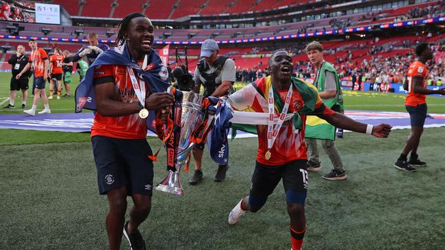 Luton Town's players celebrate on the pitch after Luton win the penalty shoot-out in the English Championship play-off final. (Photo by ADRIAN DENNIS / AFP)