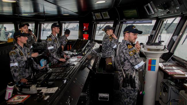 Bridge crew staff navigate the landing helicopter dock ship HMAS Canberra though Sydney Harbour on the way to an amphibious-warfare exercise. Picture: ADF