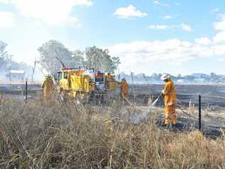 CLOSE CALL: Rural firefighters douse embers after putting out a fire at Bororen. Picture: Greg Bray