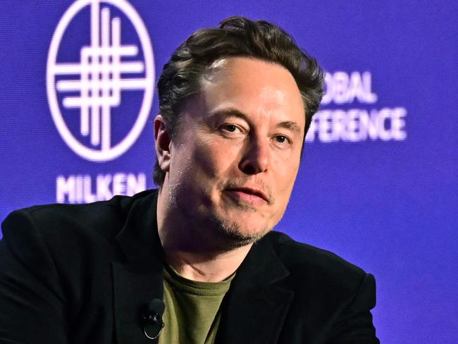 (FILES) Tesla CEO Elon Musk speaks at the 27th annual Milken Institute Global Conference at the Beverly Hilton in Los Angeles on May 6, 2024. Tesla and SpaceX tycoon Elon Musk lashed out June 10, 2024 at a partnership between OpenAI and Apple, saying the threat to data security will make him ban iPhones at his companies. (Photo by Frederic J. BROWN / AFP)