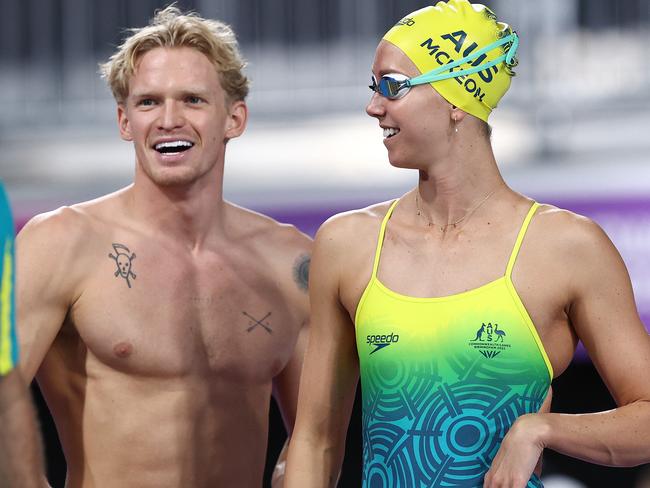 Australian swimmers and love birds Emma McKeon and Cody Simpson warm up at the Commonwealth Games.