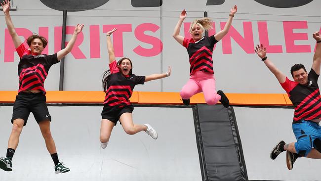 Bounce staff Jackson Cone, left, Caitlin Byrne, Imogen Collins and Troy McLean jump for joy at the reopening of the popular Grovedale trampoline centre. Picture: Alison Wynd