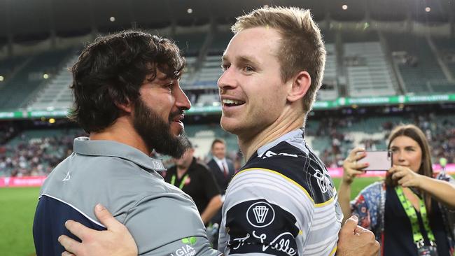 Michael Morgan celebrates a victory with Johnathan Thurston.