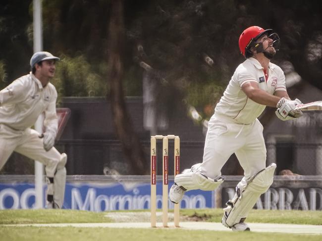 Sorrento opening batsman Corey Harris hits out as Langwarrin keeper Tom Hussey watches on. Picture: Valeriu Campan